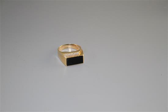A 14k yellow metal, diamond and black onyx set dress ring, size U/V, gross weight 8.4 grams.